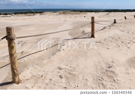 Tourist trail through the Lacka gora dune near Leba village in the Slovincian National Park, Poland 108340348