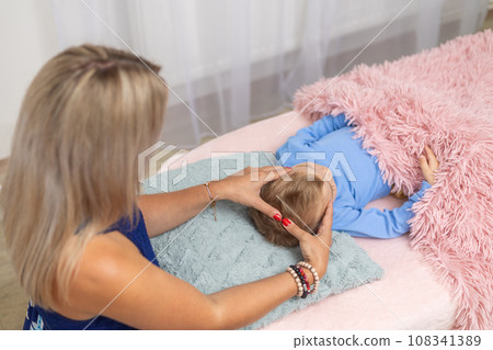 Woman healer performing access or consciousness bars to young boy, pseudoscientific method of alternative medicine that focuses on massaging various points on the head, an alternative medicine concept 108341389