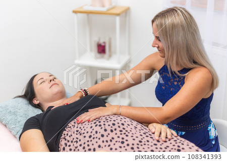 Woman healer performing and seeking access or consciousness bars to cure diseases or heal injuries by means other than conventional medical treatment, an alternative medicine 108341393