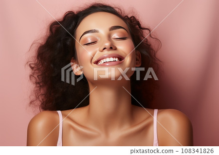 Young girl with perfect skin on her face on a pink background, a happy girl enjoys the freshness of her skin after skin care procedures Young girl with perfect skin on her face on a pink background, a happy girl enjoys the freshness of her skin after skin care procedures 108341826