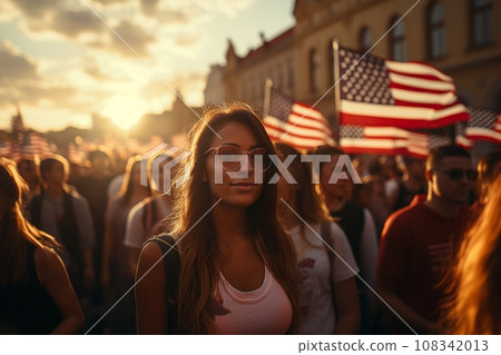 Beautiful girl against the background of a crowd of people celebrating Independence Day. Flag of the United States of America USA with fireworks for the 4th of July Beautiful girl against the background of a crowd of people celebrating Independence Day. Flag of the United States of America USA with fireworks for the 4th of July 108342013