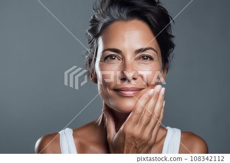 adult woman takes care of her skin, Beautiful woman with gray hair applies skin cream to her face, skin care, beauty and youthfulness of the skin of an adult woman adult woman takes care of her skin, Beautiful woman with gray hair applies skin cream to her face, skin care, beauty and youthfulness of the skin of an adult woman 108342112