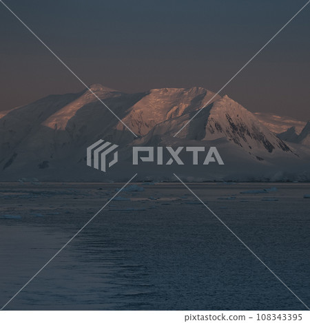 Lemaire strait coastal landscape, mountains and icebergs, Antarctic Peninsula, Antartica. 108343395