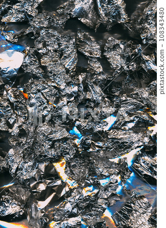 Crumpled foil texture. Shiny abstract background. Creased surface. Blue orange white color light flare rough wrinkled structure illustration poster with free space. 108343480