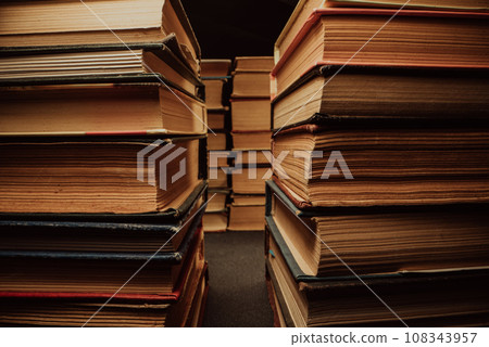 Library stack of old books. Rows in antique shop, bookstore. Vintage literature. Library stack of old books. Rows in antique shop, bookstore. Vintage literature. 108343957