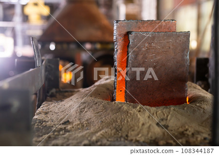 Ferrous metal billet is melted in an induction furnace closeup 108344187