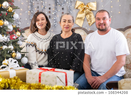 Happy family - adult children wishing Merry Christmas to their grandmother 108344208