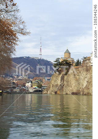 Metekhi church and Houses on the edge of a cliff above the river Kura Metekhi church and Houses on the edge of a cliff above the river Kura 108344246