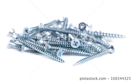 Chrome screw on white background. Tapping screws from steel close-up 108344325