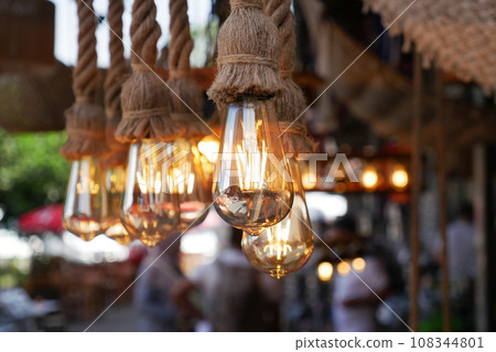 Burning stylish light bulbs at cafe Burning stylish light bulbs at cafe 108344801