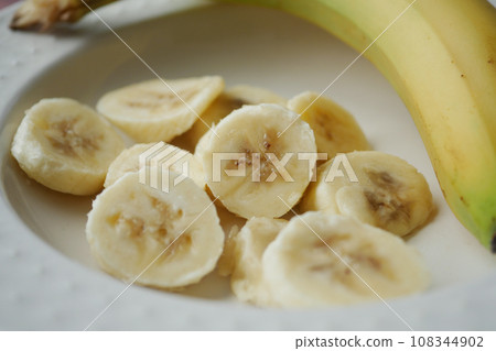 Sliced banana on a plate closeup Sliced banana on a plate closeup 108344902