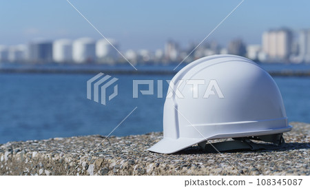 Helmet, sea and industrial area 108345087