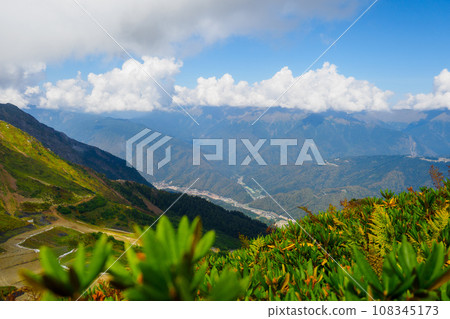Beautiful view of mountain valley on summer day with cumulus clouds in sky. Beautiful landscape of Beautiful view of mountain valley on summer day with cumulus clouds in sky. Beautiful landscape of 108345173