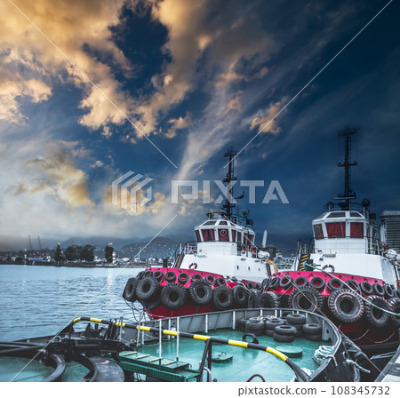 Two tugboats in the port at sunset 108345732
