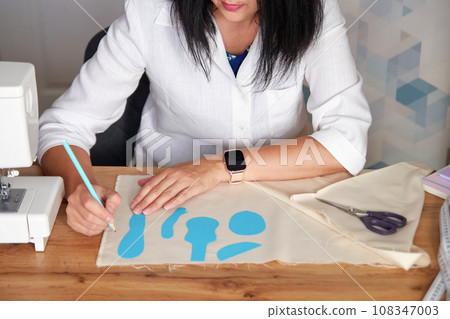Creative woman working on sewing patterns. Creative woman working on sewing patterns. 108347003
