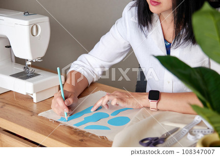 Creative woman working on sewing patterns. 108347007