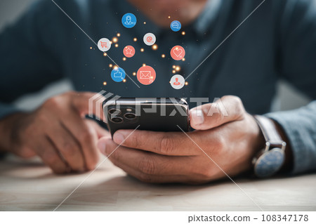 Digital connectivity at home man chats on smartphone, discussing live chat social network concepts. Icons appear in chat box, portraying modern communications role. Social media marketing technology Digital connectivity at home man chats on smartphone, discussing live chat social network concepts. Icons appear in chat box, portraying modern communications role. Social media marketing technology 108347178