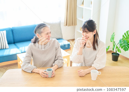 Senior woman and young woman talking friendly in the room Senior woman and young woman talking friendly in the room 108347597