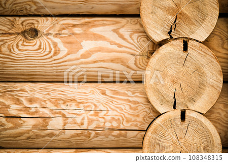 Natural background pattern of log wall. Construction of houses made of wood, rounded timber Natural background pattern of log wall. Construction of houses made of wood, rounded timber 108348315
