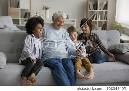 Happy multigenerational family enjoy videocall using smartphone Happy multigenerational family enjoy videocall using smartphone 108348405