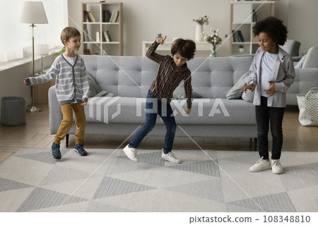 Three boys spend time together dancing in living room 108348810