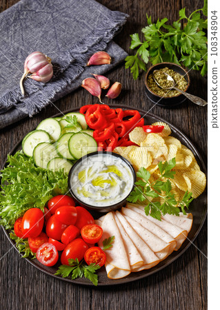 ham, chips, leafy greens, veggies snack platter ham, chips, leafy greens, veggies snack platter 108348904