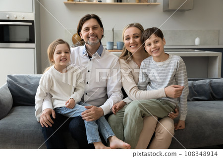 Joyful parents holding daughter and son kid on laps 108348914