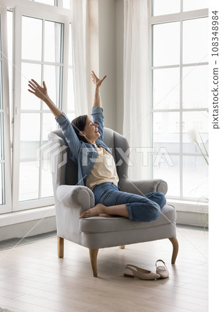 Happy woman raised her arms do stretching exercises feel rested 108348984