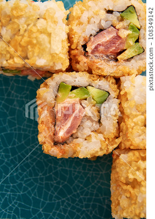 Warm sushi rolls with tuna and avocado. Warm sushi rolls with tuna and avocado. 108349142