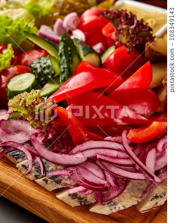 Sliced herring served with assorted vegetables. Sliced herring served with assorted vegetables. 108349143