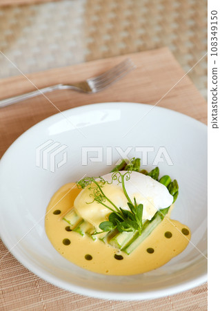 Poached egg with hollandaise sauce and asparagus. Poached egg with hollandaise sauce and asparagus. 108349150