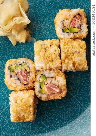 Warm sushi rolls with tuna and avocado. Warm sushi rolls with tuna and avocado. 108349151