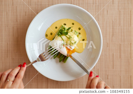 Poached egg with hollandaise sauce and asparagus. Poached egg with hollandaise sauce and asparagus. 108349155