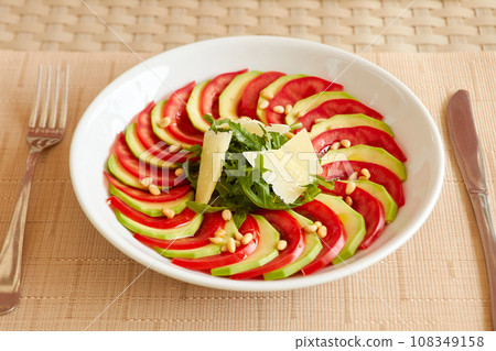 Dietary salad with zucchini, tomato, arugula and sliced parmesan. Dietary salad with zucchini, tomato, arugula and sliced parmesan. 108349158