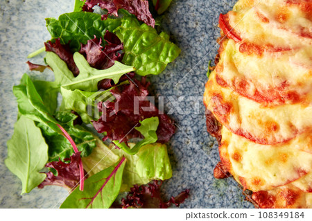 Tasty pork chop oven baked with tomatoes and cheese Tasty pork chop oven baked with tomatoes and cheese 108349184