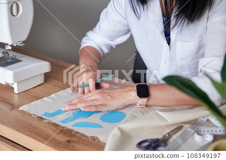Creative woman working on sewing patterns. Creative woman working on sewing patterns. 108349197