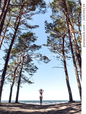 woman practicing yoga outdoors, in harmony with nature woman practicing yoga outdoors, in harmony with nature 108349234