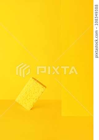 Dishwashing sponge on yellow, minimalism, monochrome. 108349388