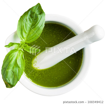 Basil pesto in mortar on white. 108349412