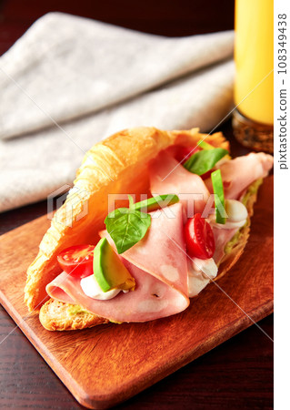 Croissant with mortadella sausage and cream cheese. Croissant with mortadella sausage and cream cheese. 108349438
