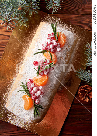 Festive Christmas meringue roll with cherries on table. Festive Christmas meringue roll with cherries on table. 108349565
