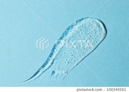 Smoothing scrub wash gel drop on blue background. 108349581
