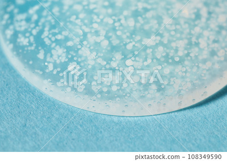 Smoothing scrub wash gel drop on blue background. 108349590