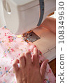 Hands of seamstress working on sewing machine. 108349630