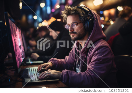 A young man with glasses at a laptop works or plays A young man with glasses at a laptop works or plays 108351201