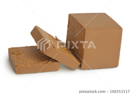 Brown cheese. Norwegian brunost isolated on white background with full depth of field Brown cheese. Norwegian brunost isolated on white background with full depth of field 108351517