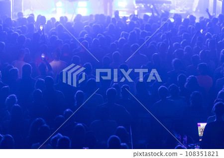A densely packed crowd at a concert. 108351821