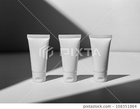Face cream, mask tubes row, three cosmetic products mockup Face cream, mask tubes row, three cosmetic products mockup 108351864