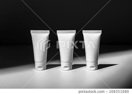 Cream tubes row, three cosmetic containers, skin care products mockup 108351880