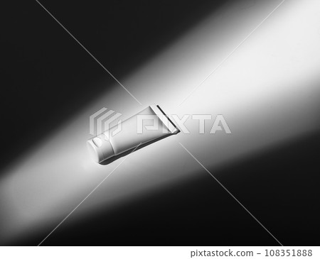 Cream tube, small cosmetic container mockup in light ray Cream tube, small cosmetic container mockup in light ray 108351888
